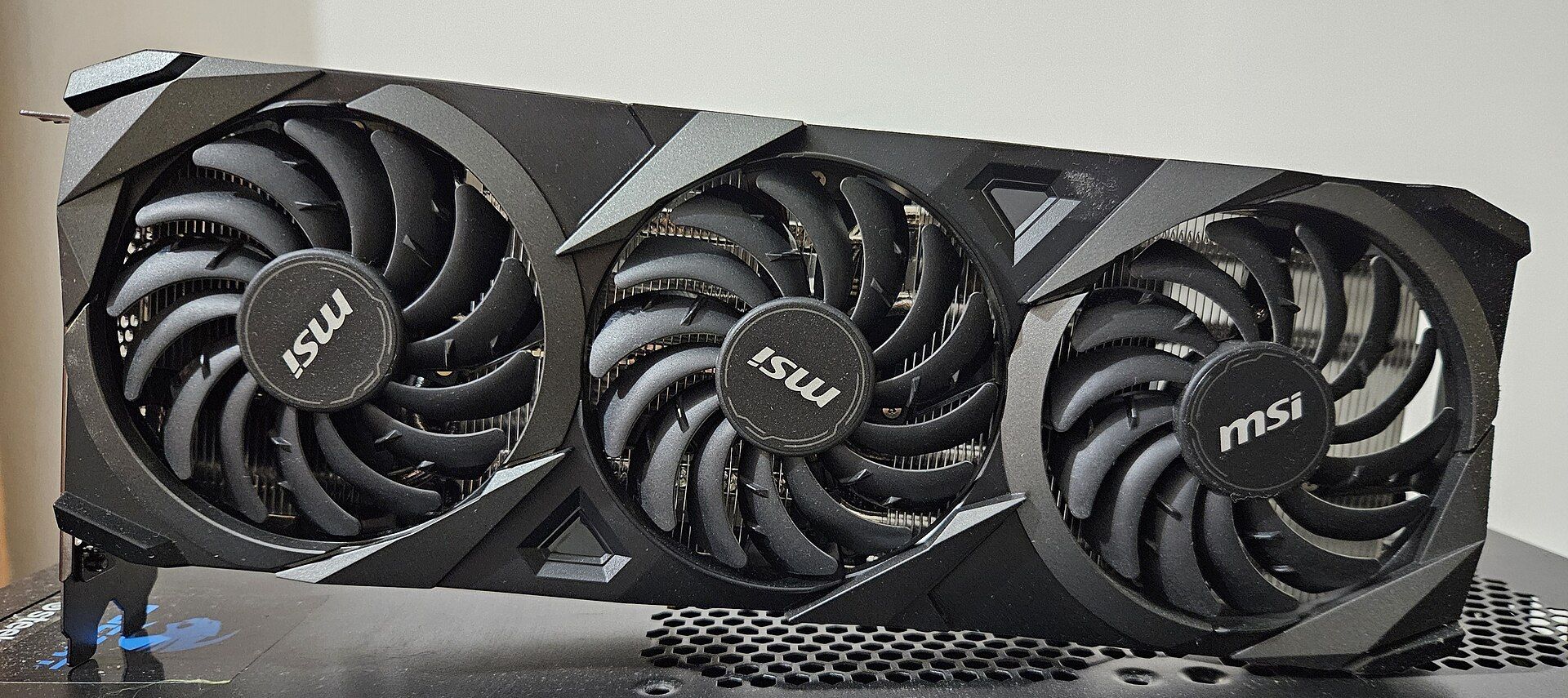 An MSI GeForce RTX 3070 graphics card with three fans, standing on a desk